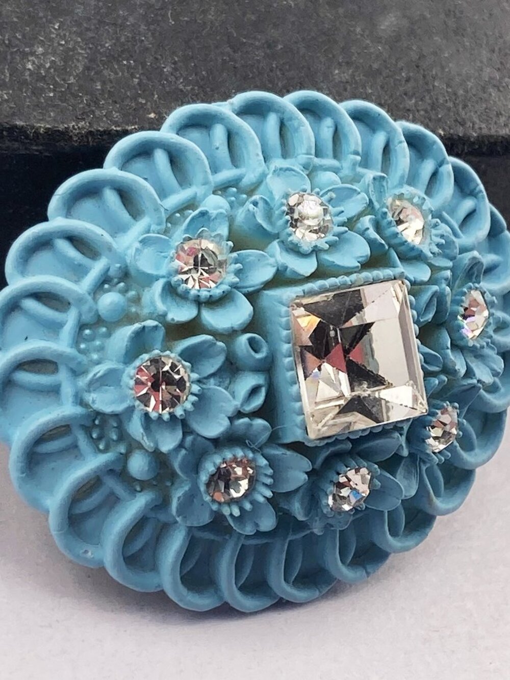 VINTAGE Blue painted plastic and clear rhinestone scalloped edge flower brooch